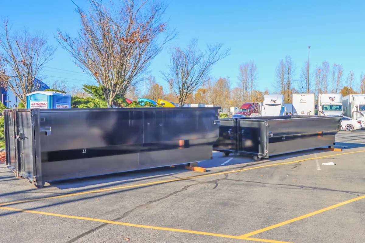 Professional dumpster rental service with roll-off container on residential driveway in Campbell